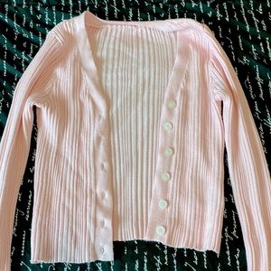 A size S pink cardigan from SheIn. It fits Xs.